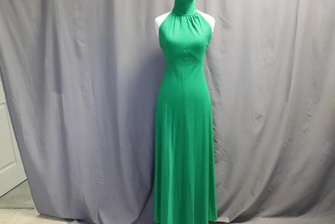 1980's Knit Maxi Dress by Youth Guild: Turtleneck detail with 5 round buttons at back of neck, zipper in back, skirt is cut on the bias. Labeled size 10, measures approx. 34 at bust, 26 waist, 53 long. In good condition.