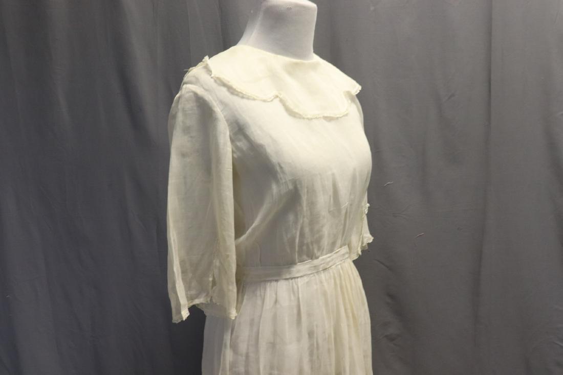 Edwardian Sheer Voile Girls Dress: Scalloped edge collar, narrow French Lace edging, shell buttons in back, gathered skirt. Measures approx. 34 bust, 30 waist, 40 long. Some very light soil, a few small breaks in the voile.