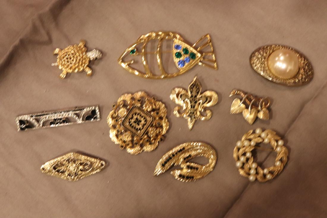 Lot of 10 Vintage Gold Tone Brooch Pins: Ciro heart pin, Tahari wreath brooch with faux pearls, Jomaz turtle, others. All in good condition.