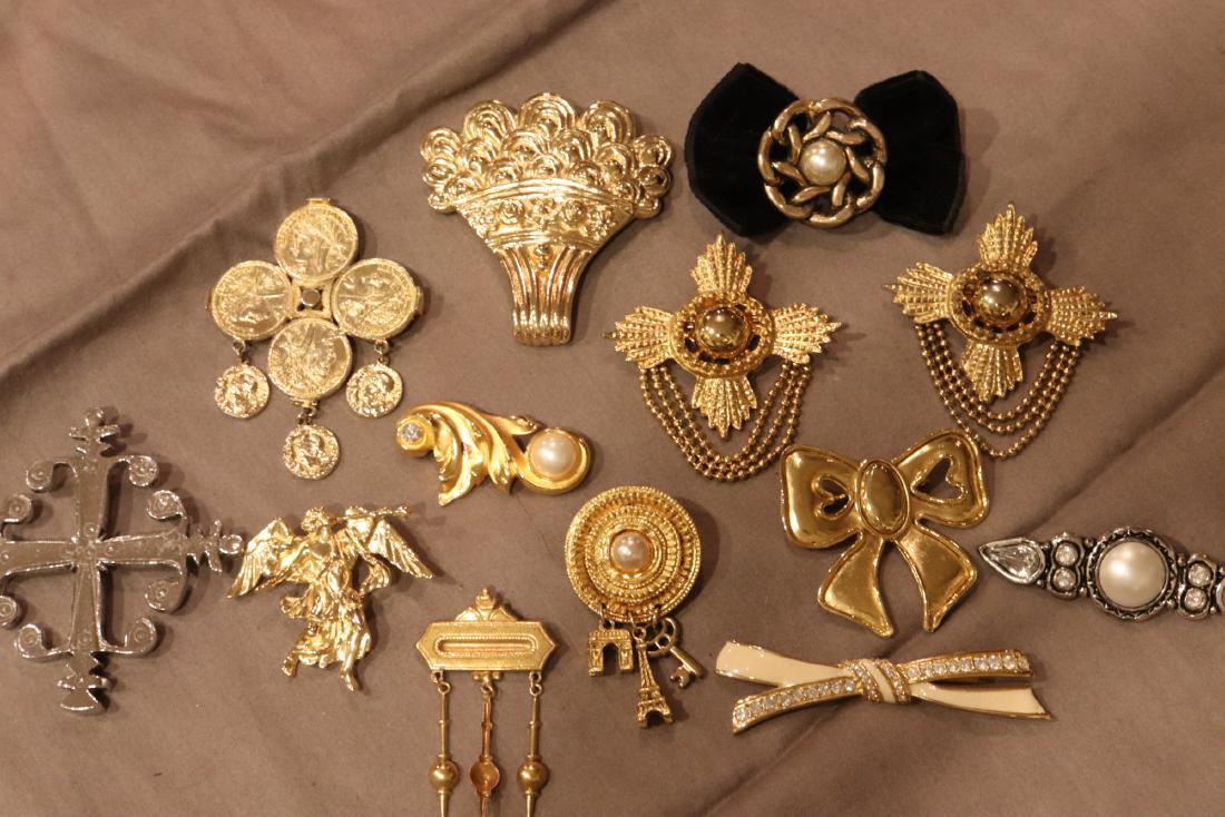 Lot 11 Vintage Gold Tone Brooch Pins, 2 Silver Tone: Trifari angel, Givenchy enameled bow pin, Cha Diorbasket pin, others. All in very good condition.