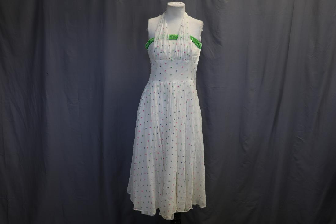 1950's Sleeveless Halter Party Dress: Boned bodice, sheer, flocked with polka dots chiffon, rayon lining, metal side zipper, green velvet ribbon at bodice top. Scattered light water marks, a few light spots at bust, a bit tattered at top