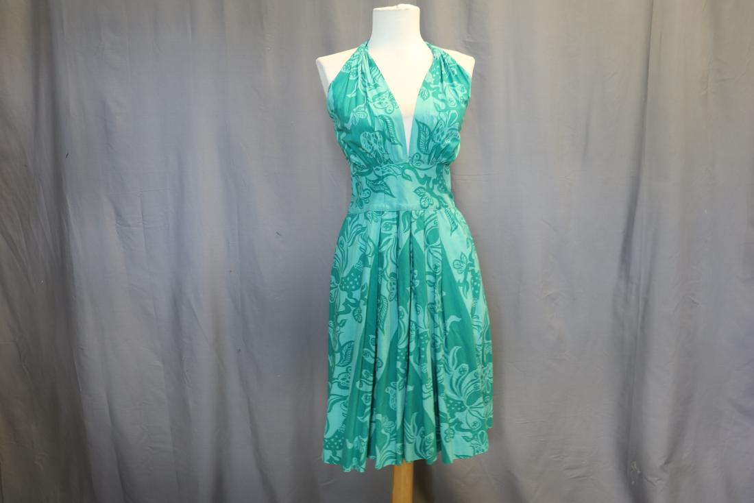 1950's Tina Lesser Design Halter Dress: aqua blue print cotton fabric, halter top that ties behind the neck, wide band at waist with boning, and pleated skirt front and back, side pockets and back zipper, approx. 32 bust, 25 waist