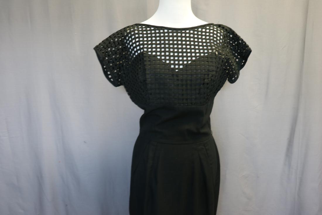 1960's Black Wiggle Dress: Bateau neck, dolman cap sleeves, bodice is basket weave design with attached under slip, empire waist with wide band, skirt with front and back darts, back zipper, fabric is a linen blend, approx. 38 