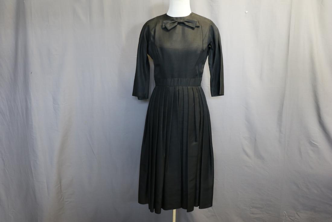 Vintage 1950 Silk Suzy Perette Black Cocktail Dress: Raw silk dress, taffeta lined, back metal zipper, pleated at waistline, princess seams, approx. 34 bust, 26 waist.
