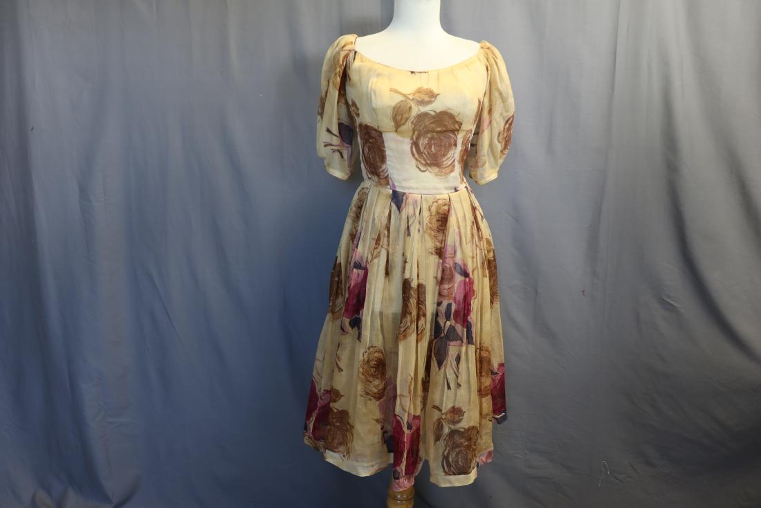 Vintage 1960's Organza Floral Pleated Pouf Dress: Printed organza dress, boned bodice,40 long. side metal zipper, pleated skirt, pouf sleeves, the bodice is lined, the skirt is not, slight discoloration throughout, a few small holes, see photos. Appr