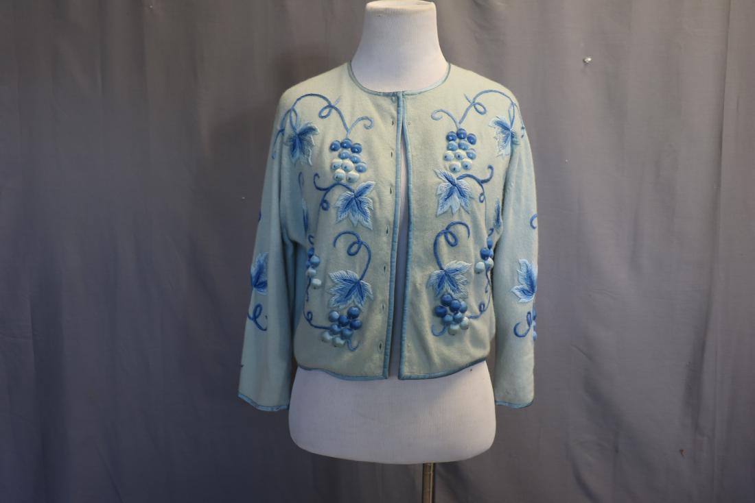Vintage 1950's Ladies embroidered Grape Cardigan: Blue wool sweater with padded embroidery design, silk lined (bodice only), satin binding on sleeves, around neckline, front and back, approx., 38 bust, 17 long. Missing closures in front. One small ho