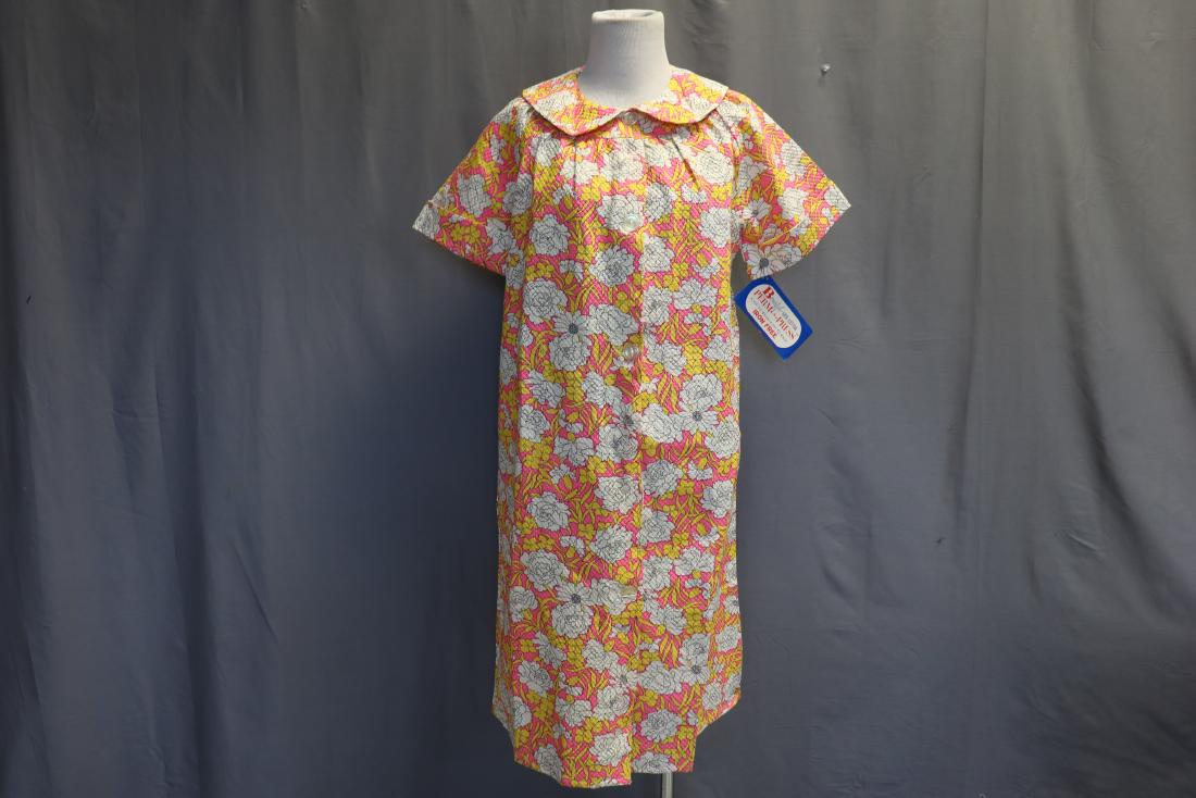 Joan Starr' Vintage 1950 housecoat: Seersucker floral print housecoat, button front, rounded collar, slightly gathered at upper bodice back and front, one side pocket, old store stock with original tags, approx. 42 bust, 40 long.