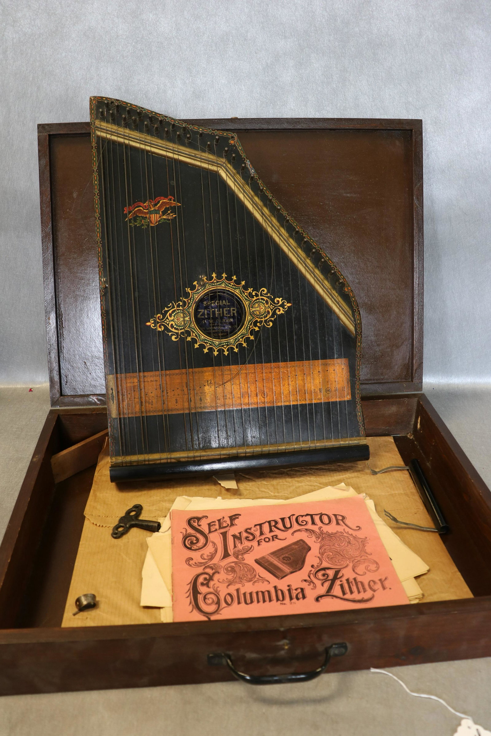 Antique Columbia Zither in Case: With key, instructions, case, measures approx. 22x16" in case.