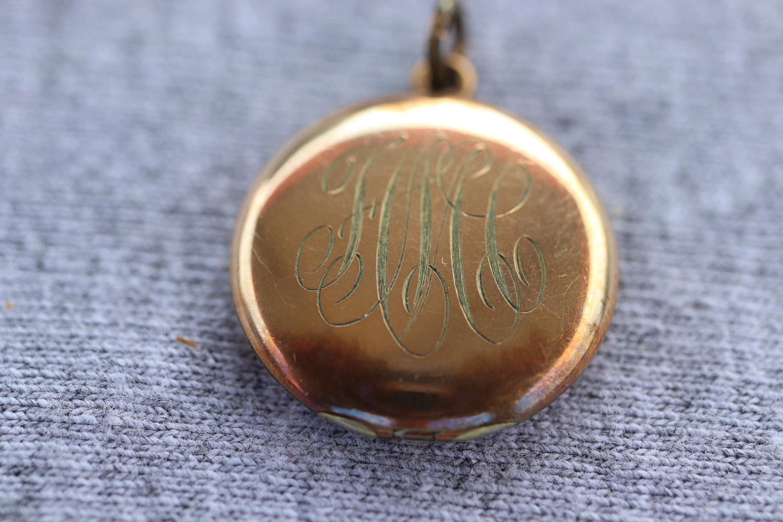 Vintage Monogramed Locket Pendant: gold tone monogramed locket with pictures inside, no markings, approx. 1 inch closed