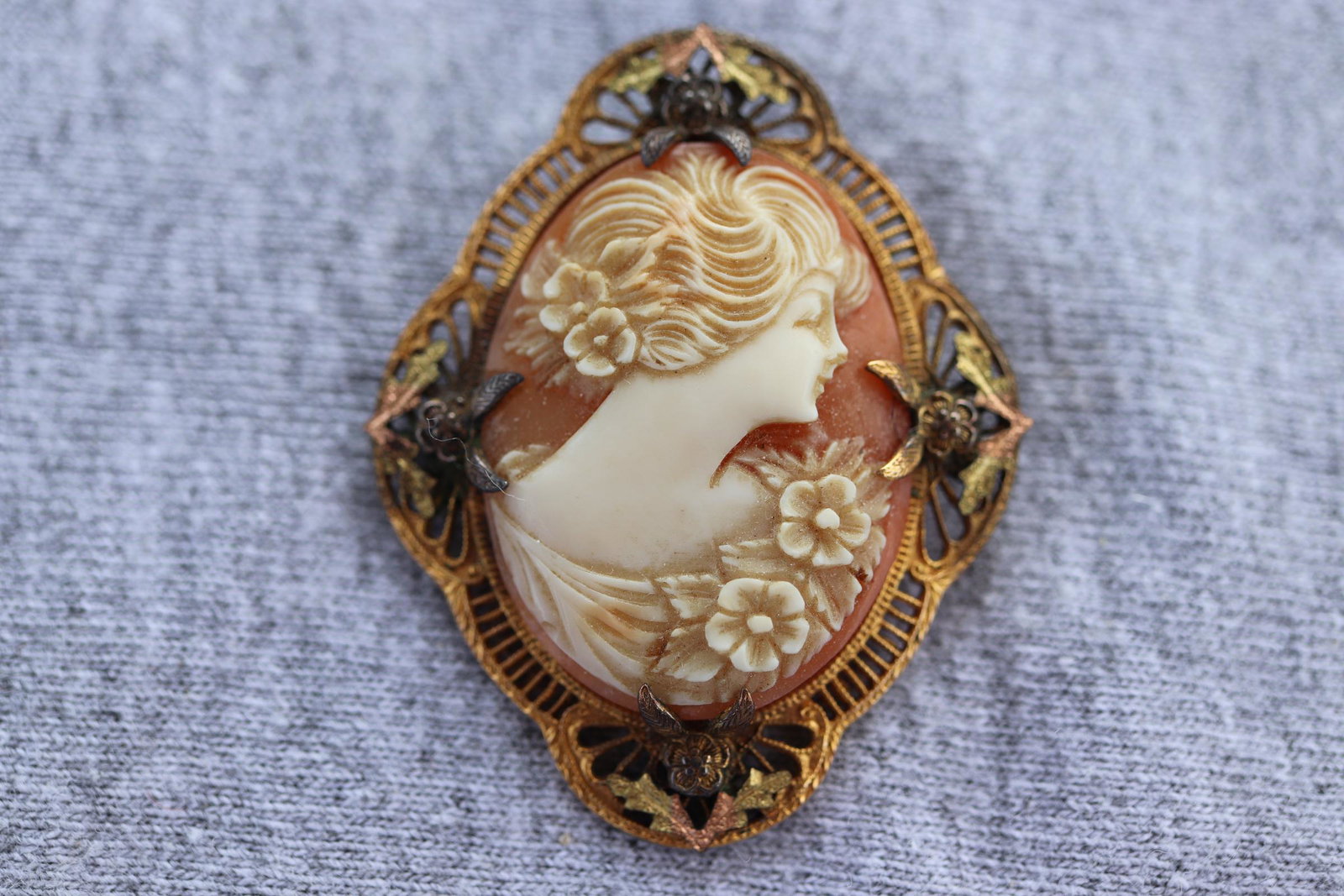 Antique Art Neadeau Cameo Brooch: gold tone fret work frame with silver tone floral marcasite detail, hand carved cameo of a woman with flowers in her hair and at shoulder, beautiful piece, no markings, approx. 1 5/8 inches