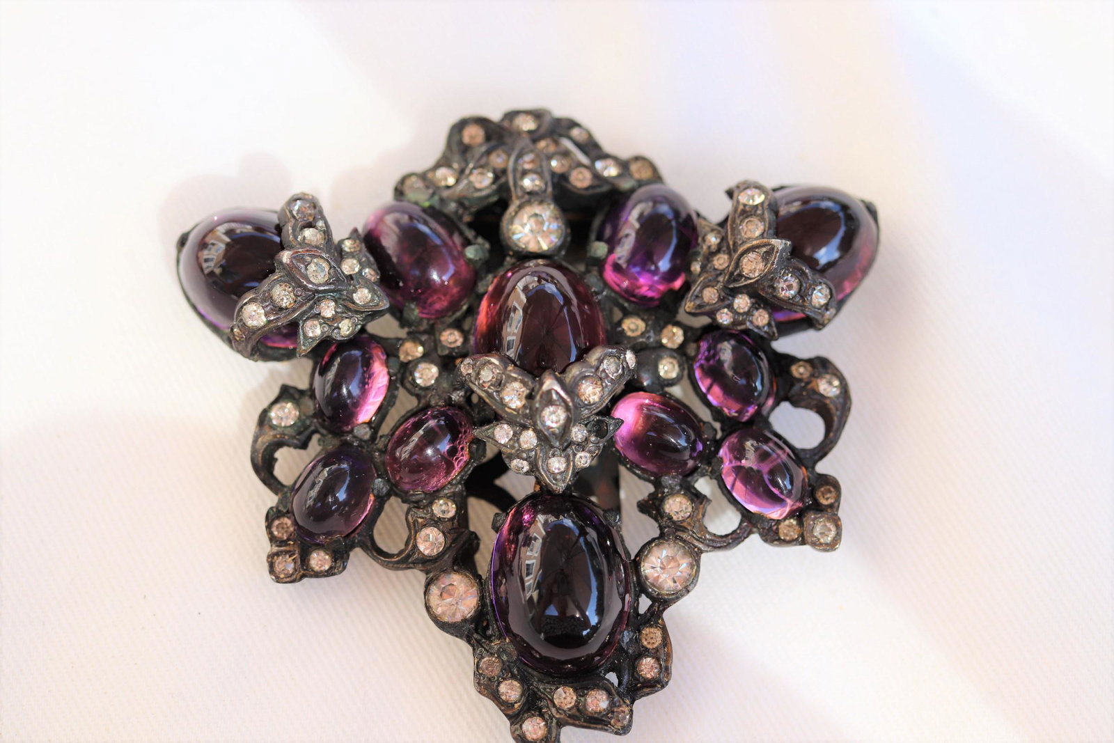 Large Antique Art Deco Dress Clip W Rhinestones: Deep purple stones, tiny rhinestones, approx. 2 1/1" tall.