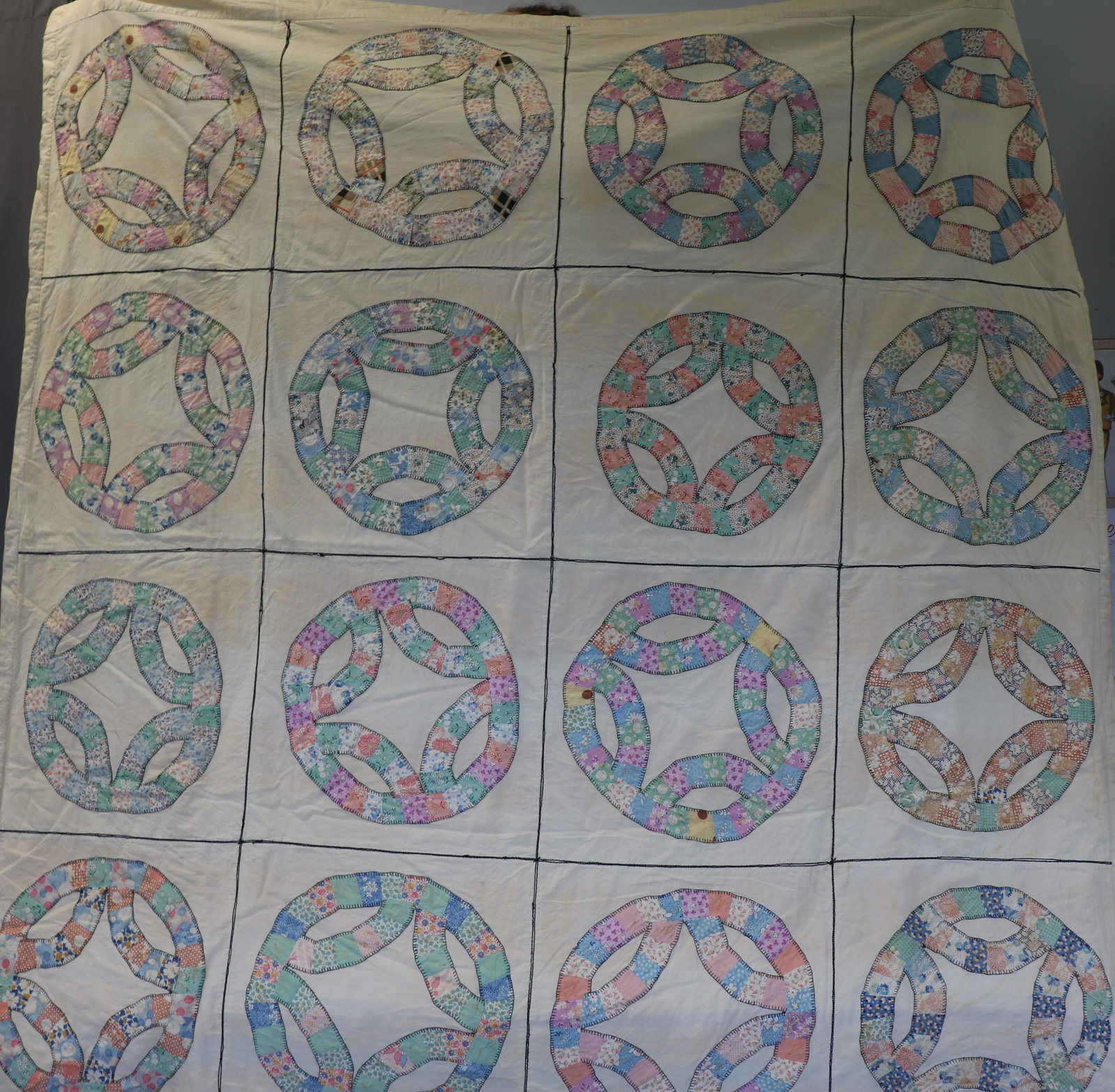 Vintage 1930's Wedding Ring Variation Quilt: Approx. 66x66". Light discoloration on the muslin, some color fading on the calico prints, light soil on a few squares