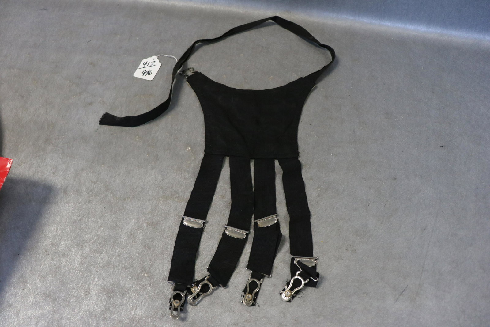 Antique 1900 Foster Black Garter Belt, Hose Supporter: Unusual design, meant to hold the female frame in the 'right' position. "Rubber Button" imprinted on the rings. Top piece approx. 7x8" . Nice condition.