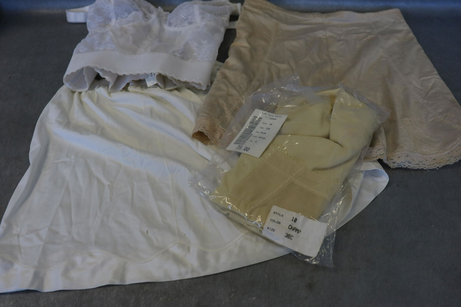 Lot of Vintage Lingerie: old stock Bustier from lady grace size 38C, Bali bustier in white size 38C, Vanity Fair Mini Slip with Pillow Tap size small, x-large size flexees girdle in worn condition