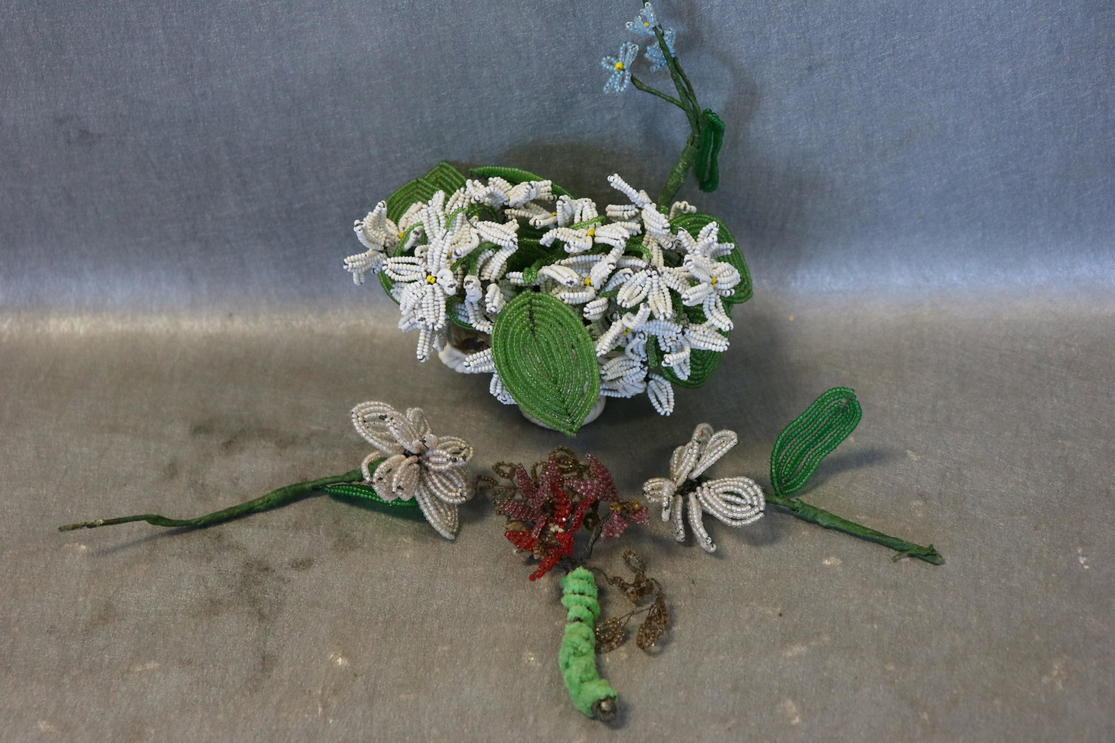 Lot of Vintage Seed Beaded Flower Bouquet, Others: Bouquet of daisy seed beads attached to porcelain basket (crown stamp on bottom). 4 other smaller floral stems. All in very good condition.