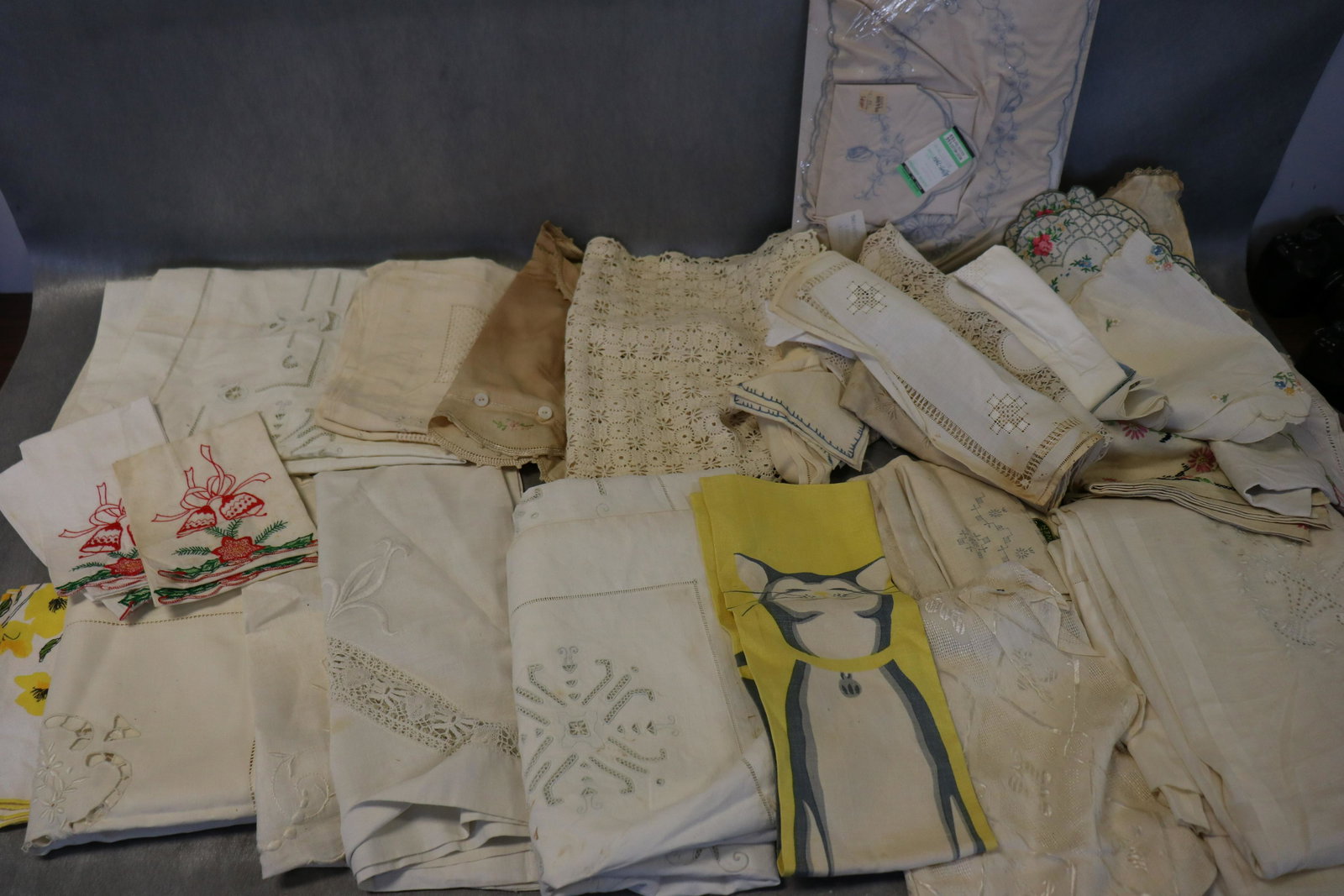 Large Lot Vintage Lines, Tablecloths, Napkins: Embroidered runners, pillow covers, napkins, towels (light scattered soil), cream lawn fabric summer bedspread with embroidered flower baskets (light soil), 2-printed linen towels to embroider, 1-old