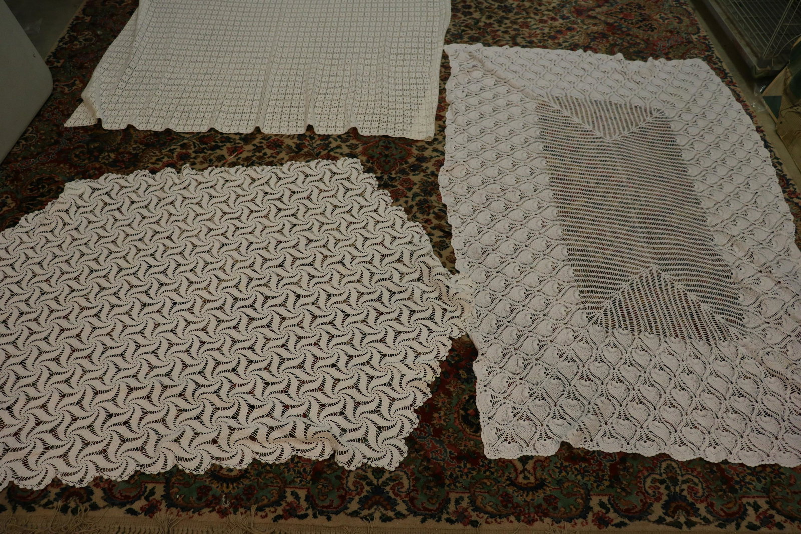 Lot of 3 Vintage Crocheted Tablecloths: All are white in color. Pineapple pattern Approx. 47x71", very light soil. Pinwheel pattern (irregular shape)approx. 43x44, some light soil. Filet crochet approx. 70x64", very good condition.