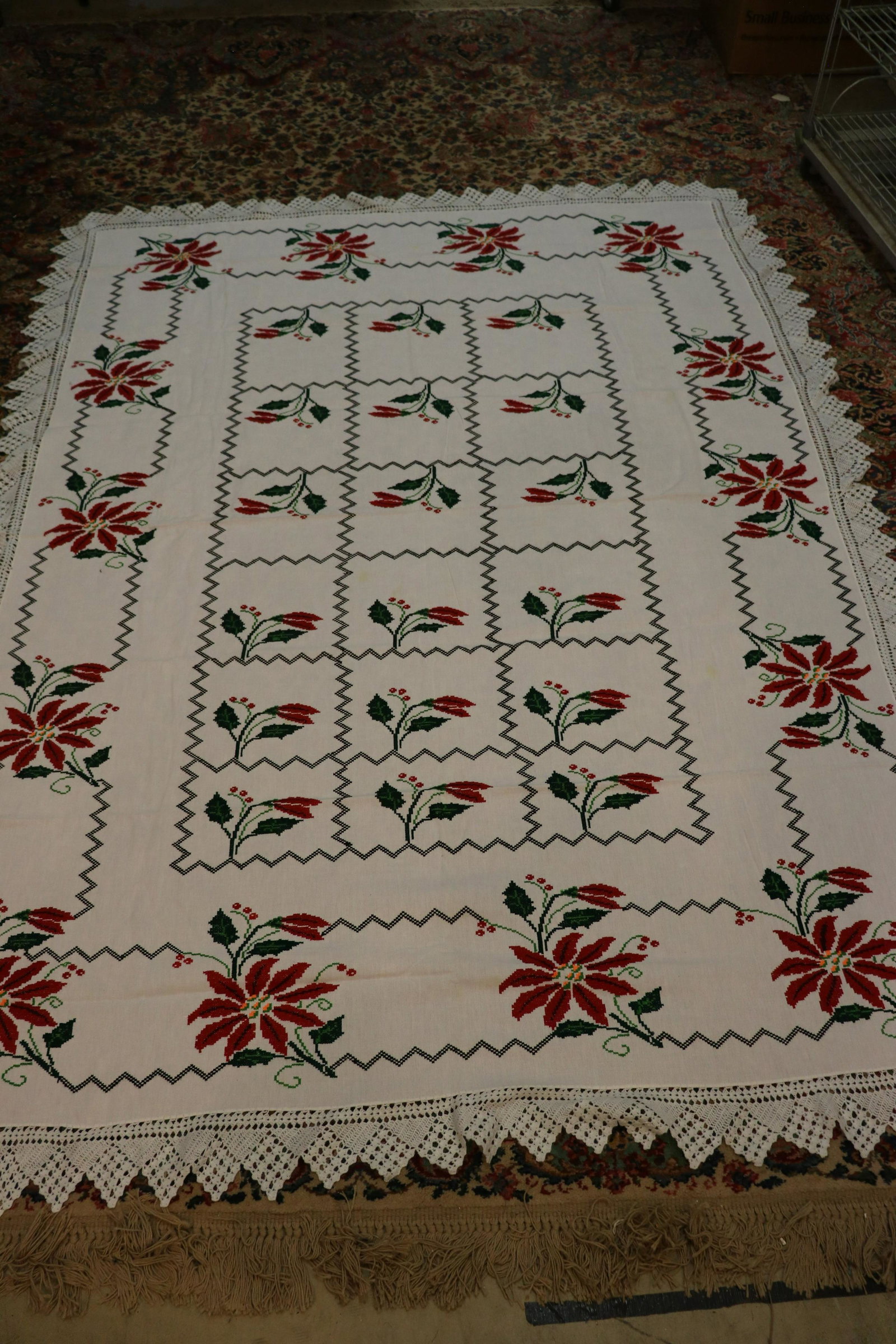 Christmas Tablecloth With Cross-Stitch Poinsettias: Measures approx. 88x68" including the crocheted edging. Some light soil spots.