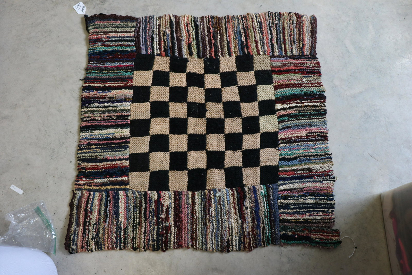Antique Checker Board Rag Rug: Checker board antique rug, appears to be constructed from strips of antique silk fabrics, approx. 33x32", 4" seam repair needed in one area, some small holes, wear, see photos.
