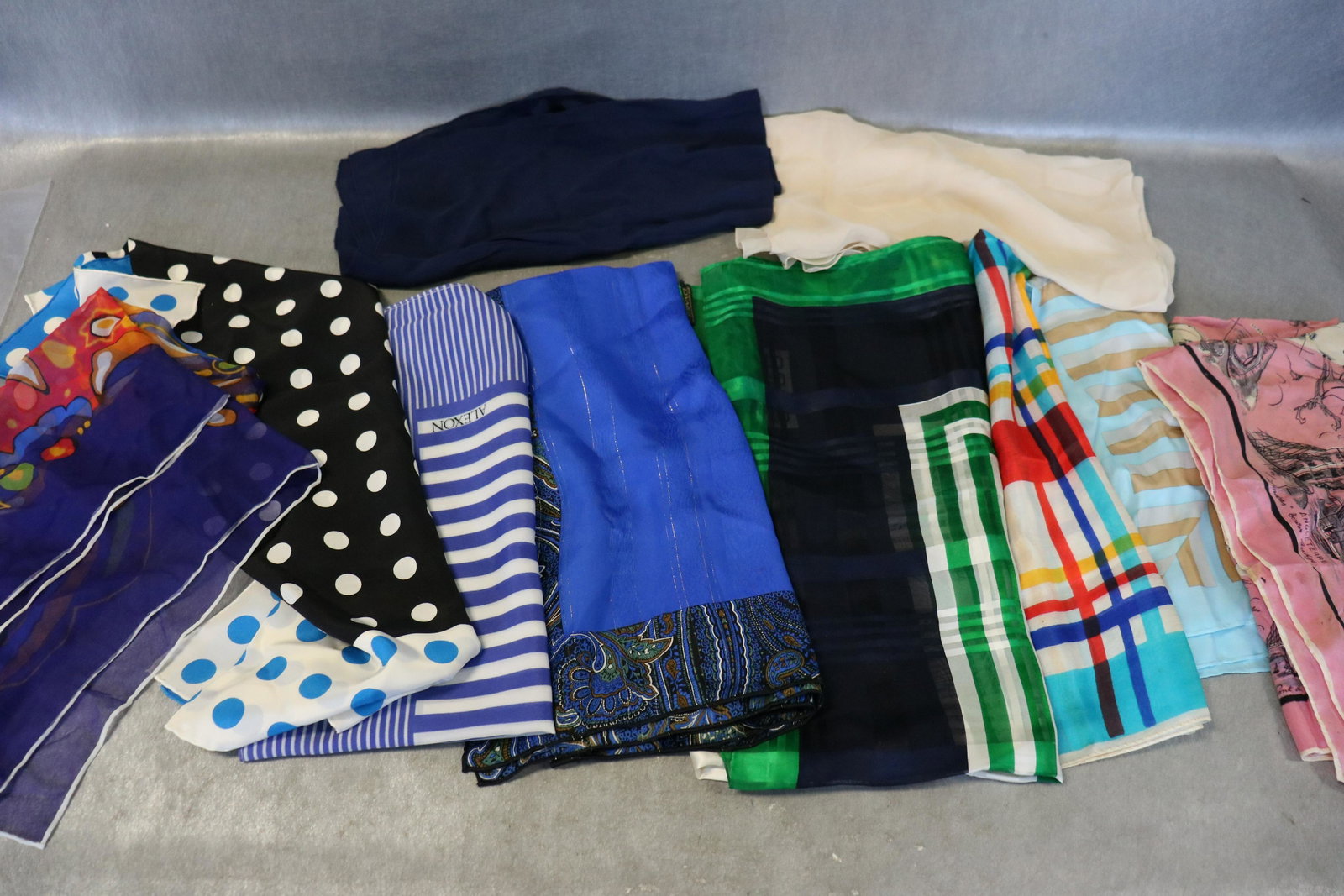 Lot Of 10 Vintage Silk Scarves: Includes Jaquy Piaget some small pulls. Plaid scarf has some small pulls, Christian Dior blue scarf with metallic threads, Alexon blue strip scarf (light soil), Italie:Venise pink silk scarf with citi