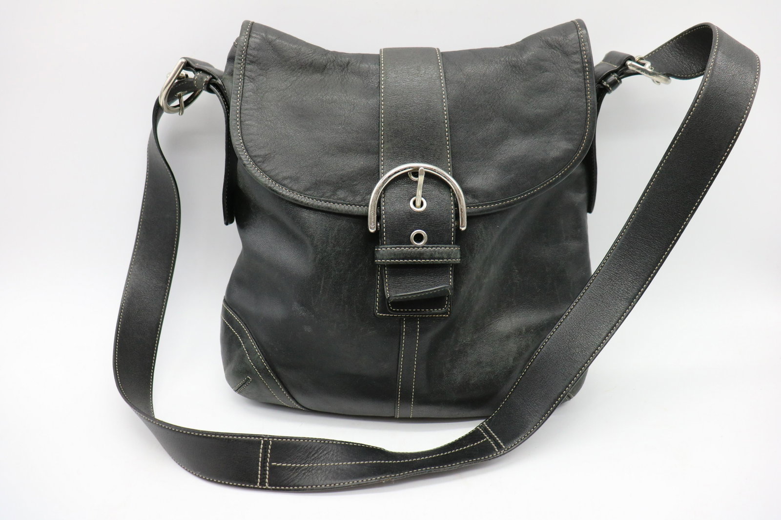 Coach Black Leather Handbag, G3S-9481: Large decorative buckle in front with magnetic snap underneath. Multiple pockets inside bag. Light wear and soil on lining and outside of bag.