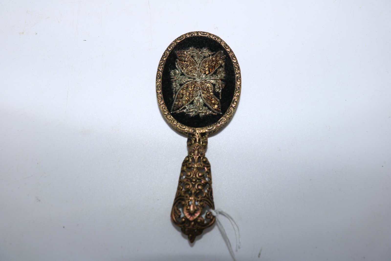 Vintage Miniature Mirror with Ornate Filigree Handle,: Mirror on one side, metallic thread embroidery on reverse. Measures approx. 4" long.