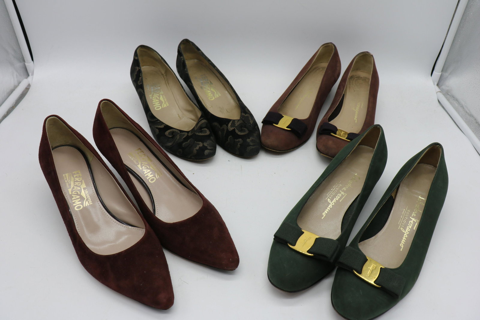 4 Pair Salvatore Ferragamo Shoes: Patterned black, size 7 1/2, heel is approx. 1 1/2", light wear. Brown suede size 7 1/2, 2" heel scuffed on bottom. One pair Brown and one green suede shoes with 1 1/2" heels, Ferragamo gold tone buck
