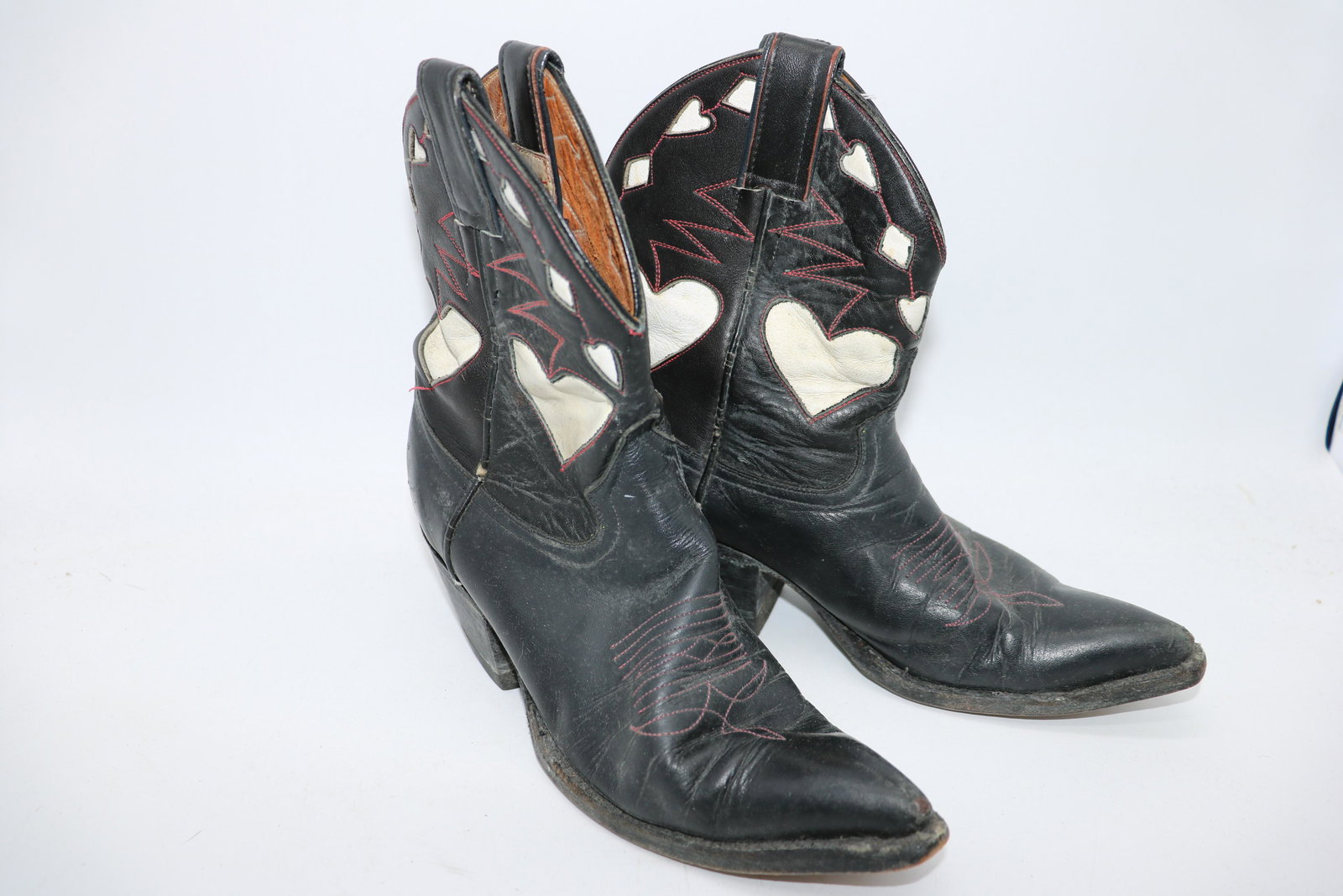 Vintage Leather Cow Boy Boots with Hearts: black leather with cut outs and inlaid with white hearts, red stitching, made in the USA, Wild Aldo approx. 10 inches tip of toe to heel on outside