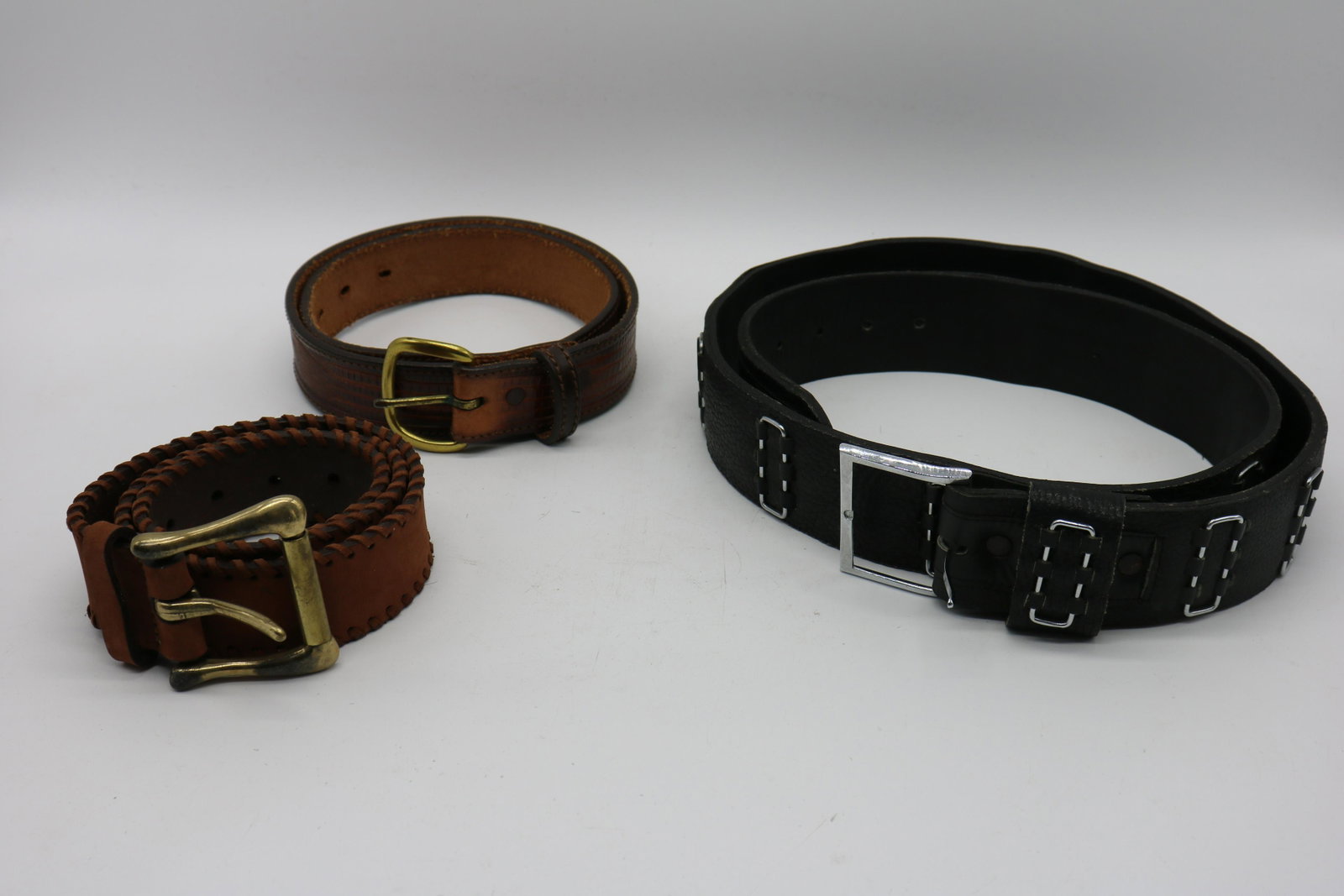 Lot Of 3 Vintage Leather Belts: Black Kidskin belt, size 46. Brown Big John, Hand Finished saddle leather, size 32, alligator-look. Jaeger made in Italy, size 75/30.