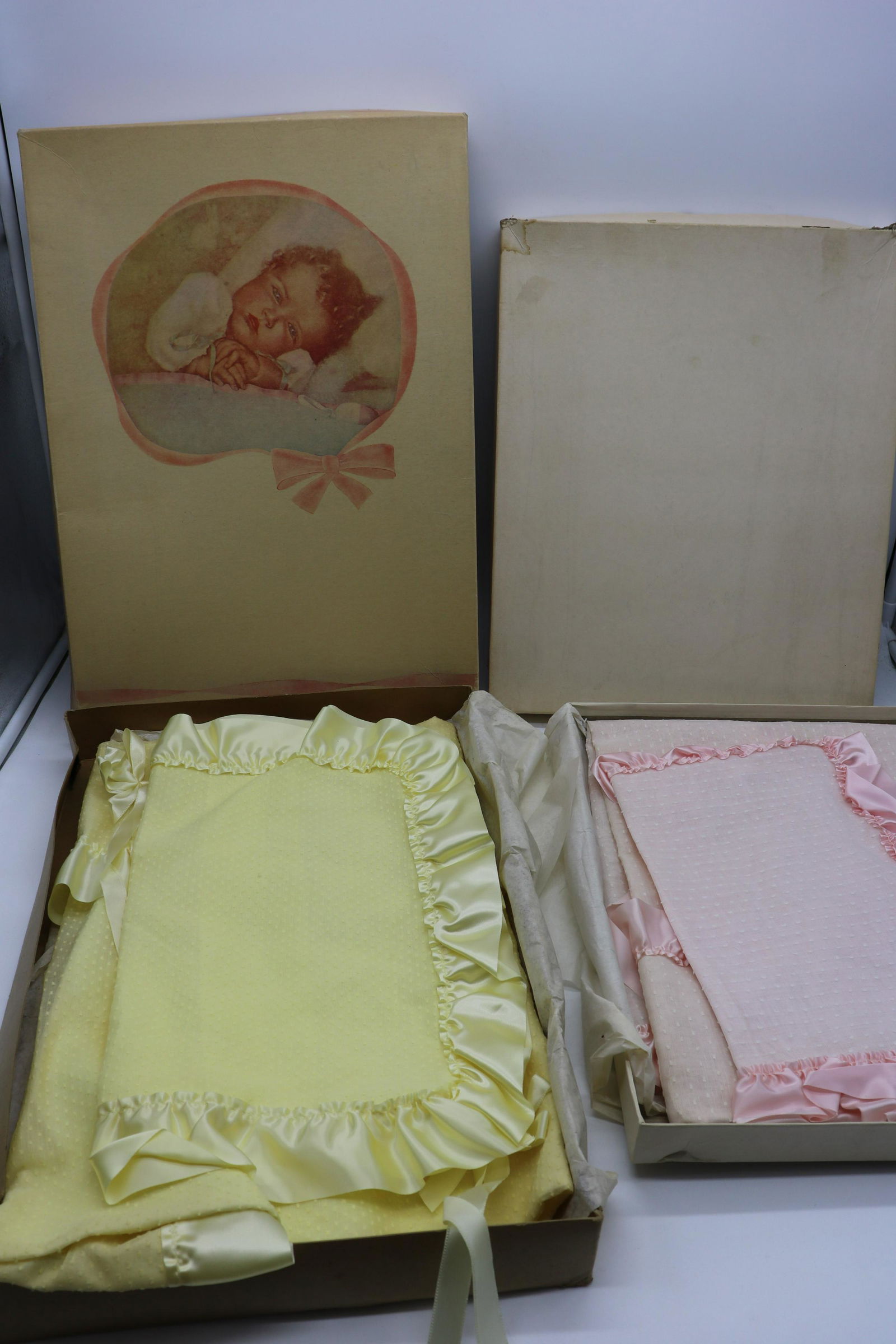 Lot of 2 Pink & Yellow Old Store Stock Baby Blankets,: Dotted Swiss , one pink, one yellow, in original Boxes, blankets approx. 25x29" , pillowcases hold a pillow approx. 15x12. Light storage soil on yellow blanket and pillowcase.