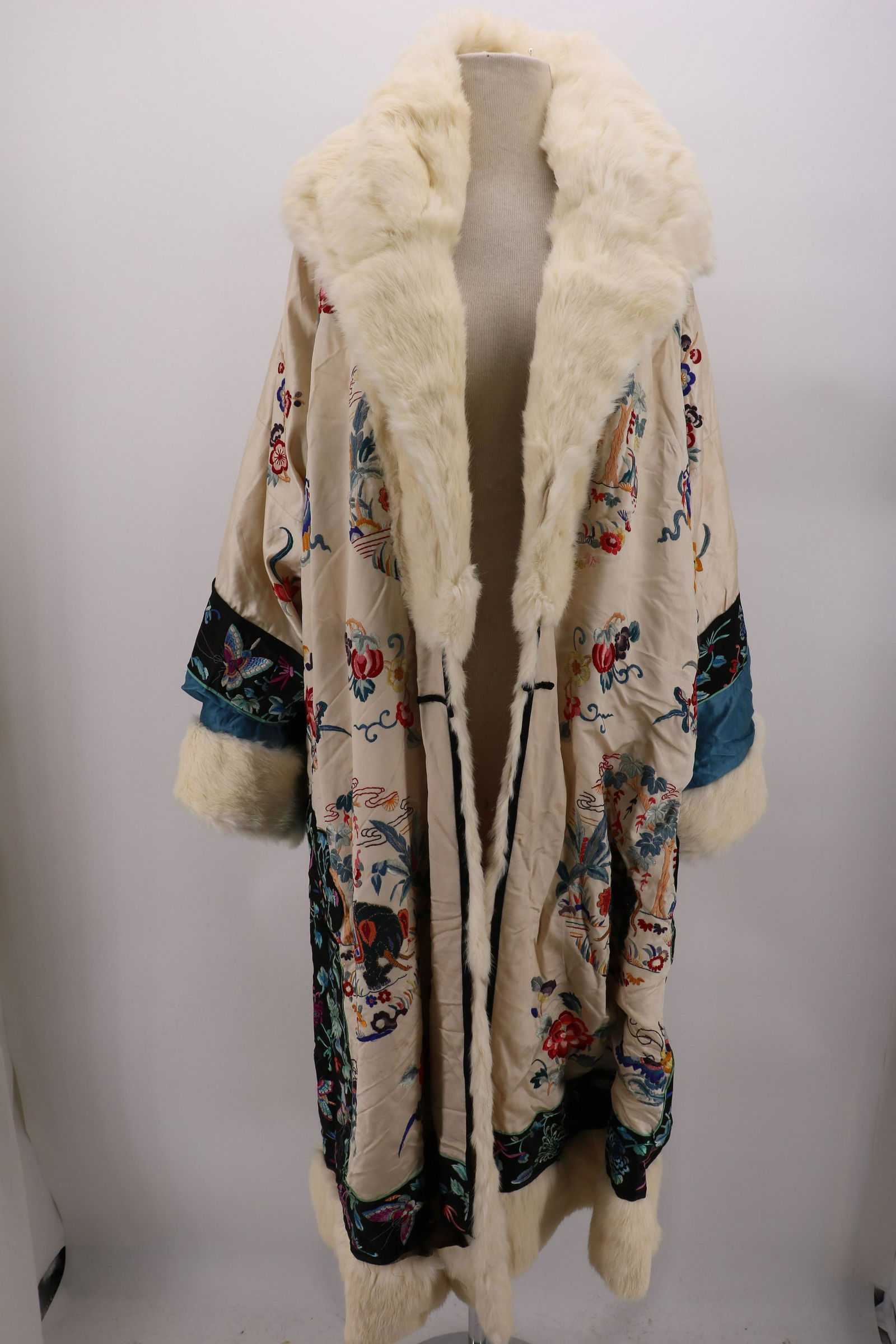 1920's Chinese Embroidered Cocoon Opera Coat: stunning embroiderer through out with flowers and elephants, long sleeves with large white fur cuffs, large fur shawl collar, believe to be a bleached mink, 3/4 length with wide fur hem, fully lined w