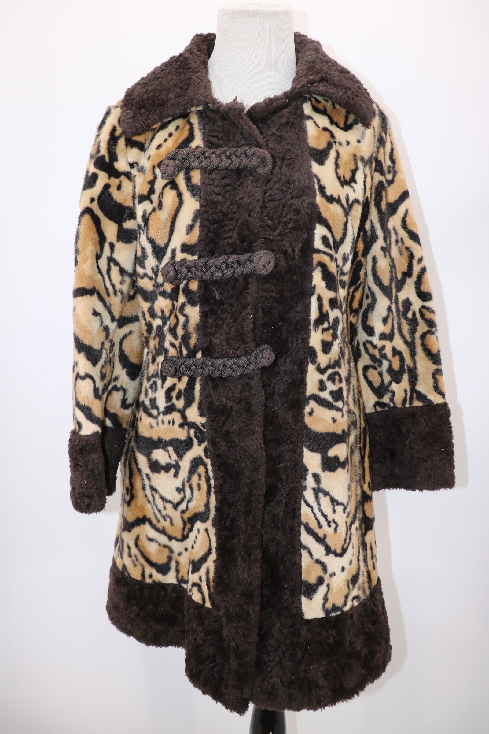 1940/50's Dell-Mann Faux Leopard Coat: faux leopard with large brown faux fur cuffs, collar and trim down the front and around the hem, large frog style front buttons, they have been moved out for larger size, side slit pockets, see photo