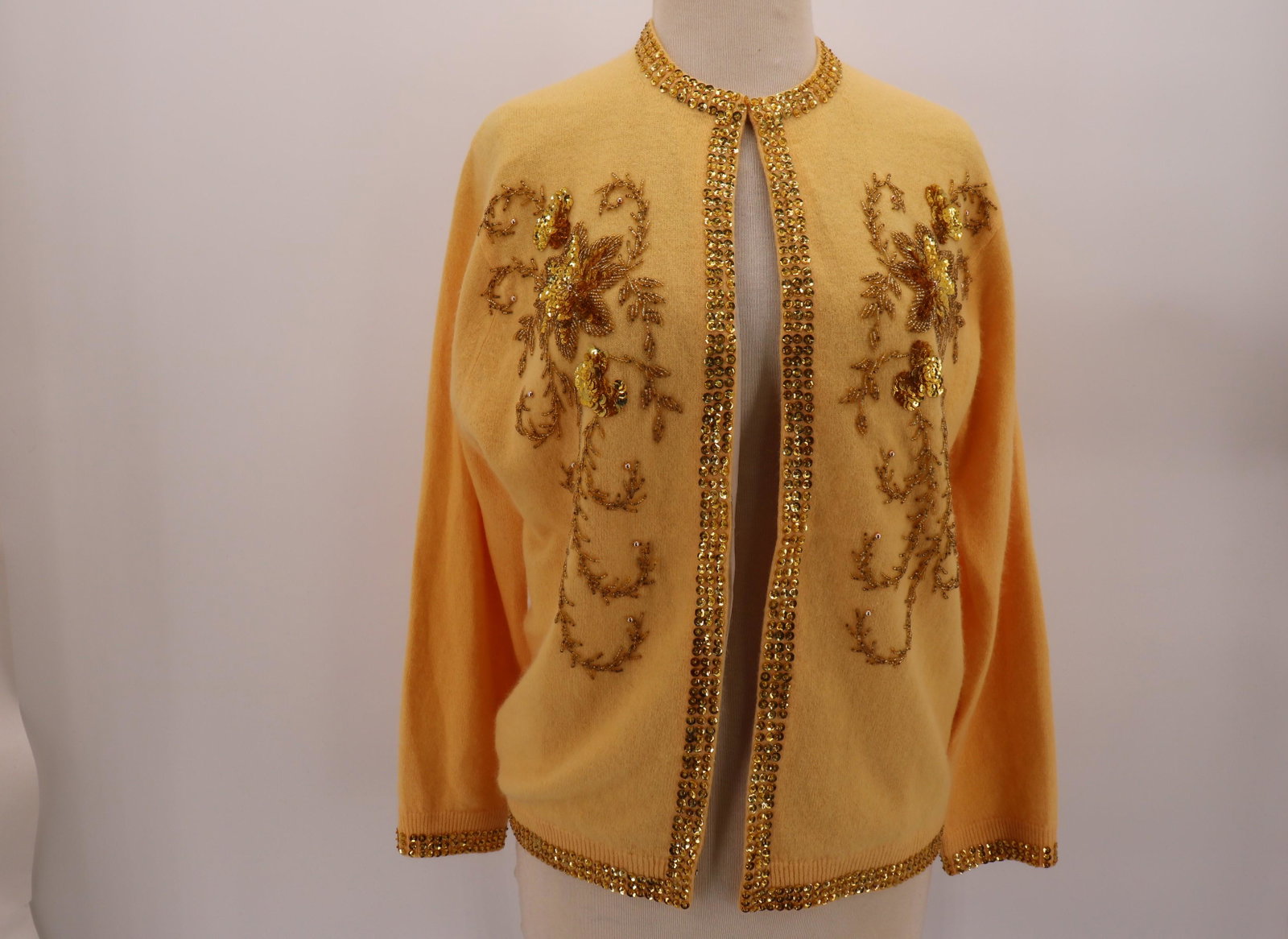 1950's Gold Angora Sweater with Beading & Sequin: beaded & sequin floral decoration down both sides of front and at back neck, sequin detail around collar down either side of front closure, around back hem and sleeve hems, eye hook closure, fully lin