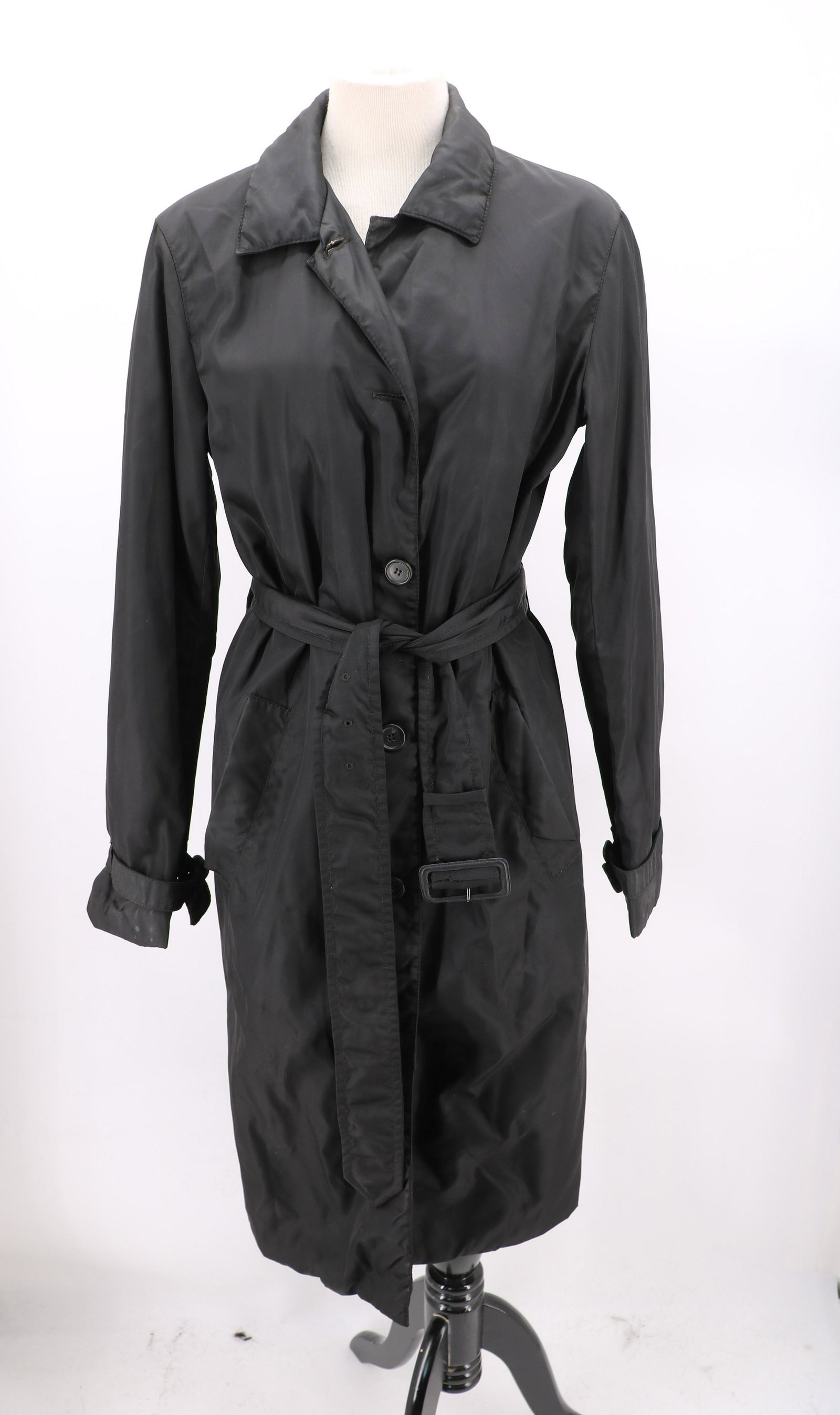 Vintage Unisex Black Nylon Prada Coat: black rain coat, comes to just below the knee, buckle sleeve cuffs, buckle belt at waist, one button missing and some stains, size 42