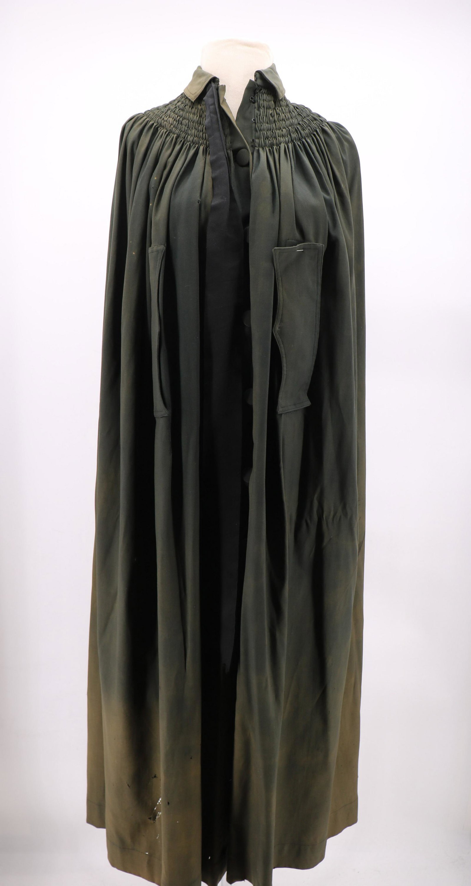 Antique Victorian Green Wool Cloak: "John Wanamaker". Smocking at shoulders and in back, covered buttons, front slits for arms (one facing needs seam repair), approx. 54 long, some small holes and fading in the wool.