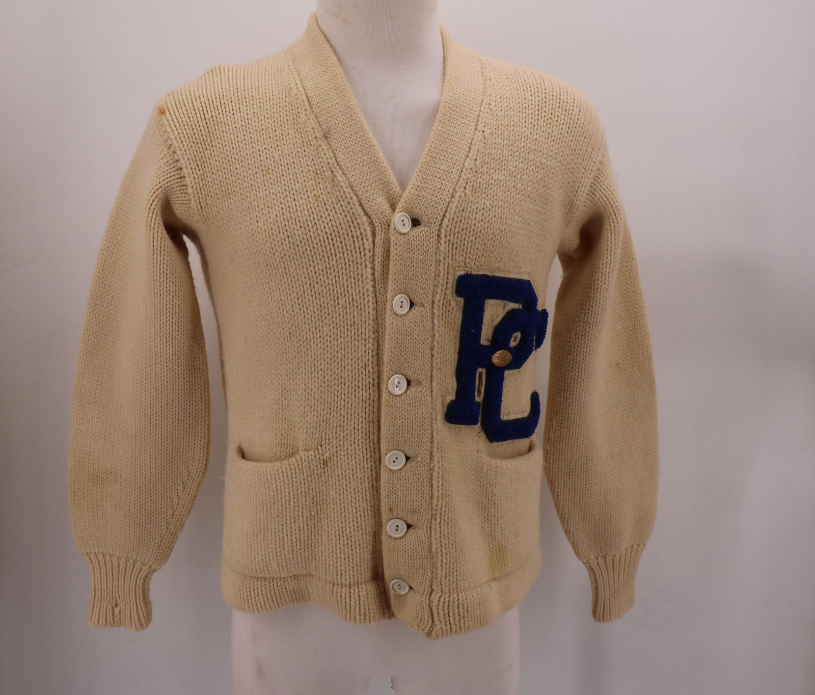 1950's Wool School Sweater With P C Initials: by Lanza, with football pin, front pockets, button front, approx. 42 bust, 23 long, some light soil on the wool.