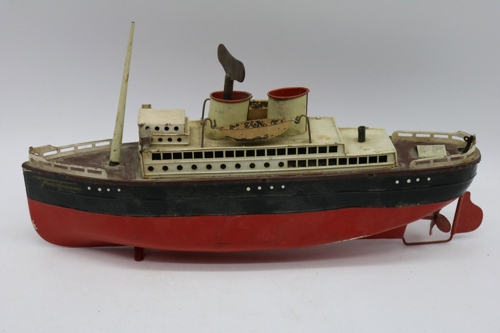 Early Fleischmann Passenger Ocean Liner Tin Windup Toy: Early Fleischmann catalogs show this as a Passenger Ocean Liner type Bremen with clockwork, or Passagierdampfer type Bremen fit Uhrwerk. It is likely number 520/40 or the model 520 at 40 cm long. Some
