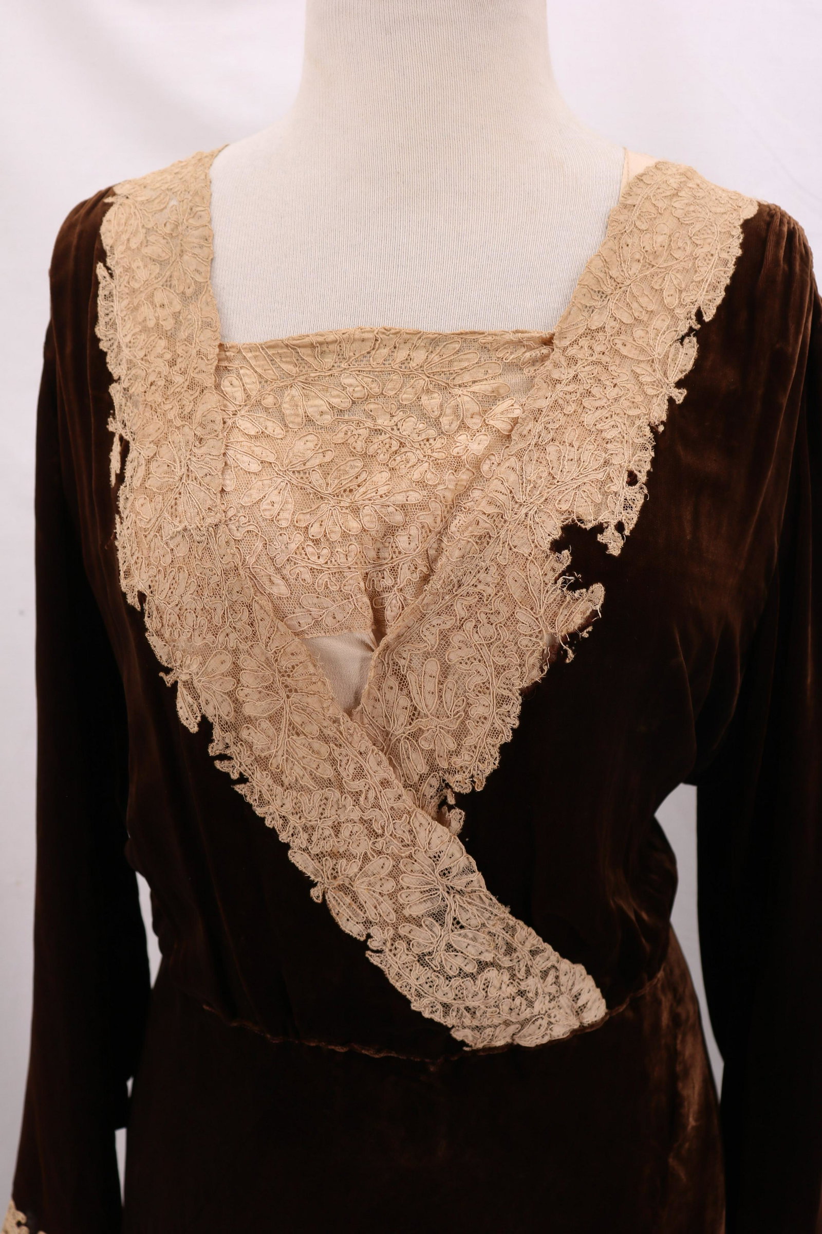 Edwardian Brown Velvet & Lace Dress: long sleeves gathered at elbow with lace cuff and snaps, smocked shoulders, lace insert square neck with lace over wrap style bodice, skirt cut and seamed at angle to give it a full flowing look, slip