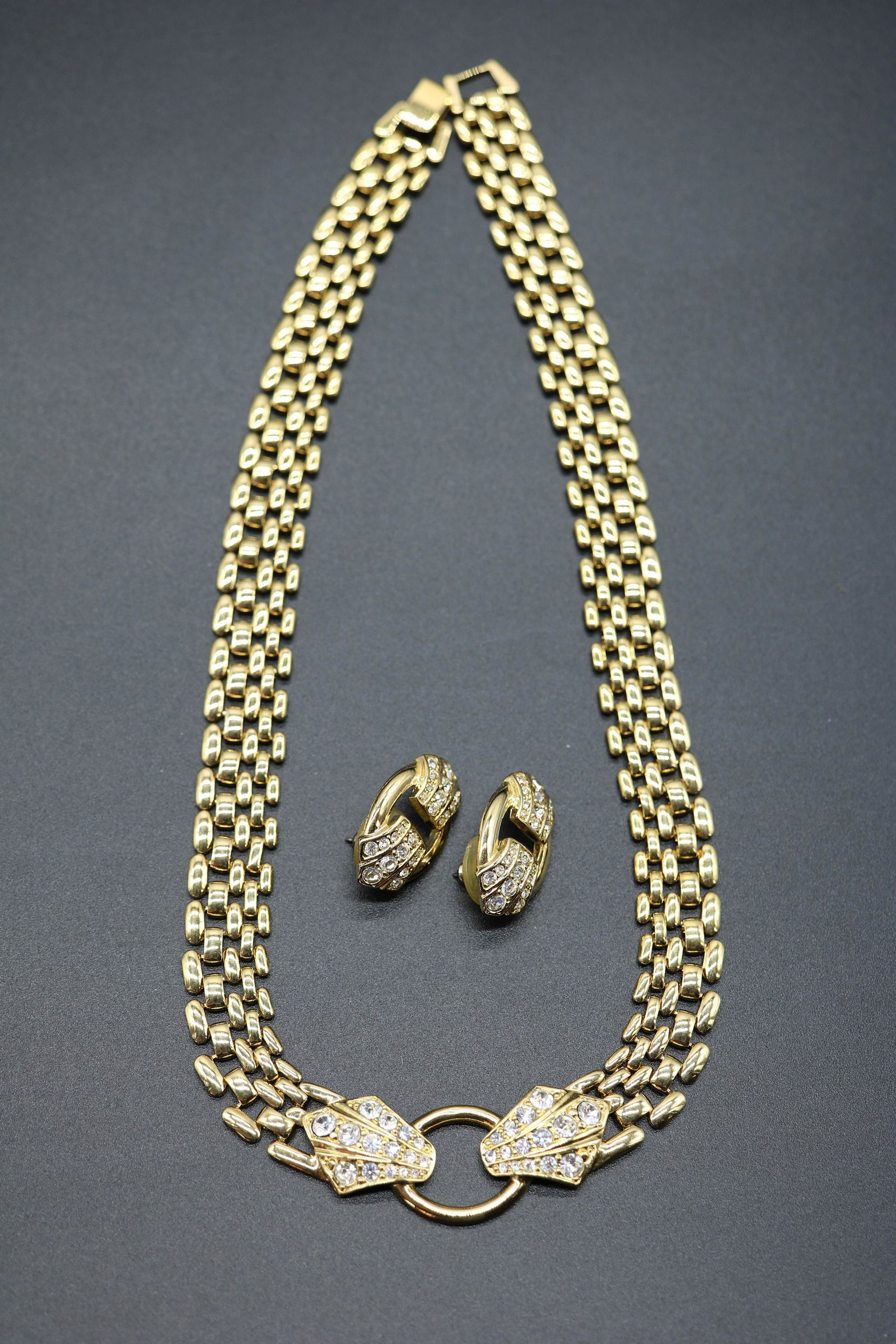 Vintage Trifari Linked Necklace & Matching Earrings: gold toned linked bib style necklace with center cirlce flanked by crystal stones, matching pierced earrings, necklace approx. 17 inches long