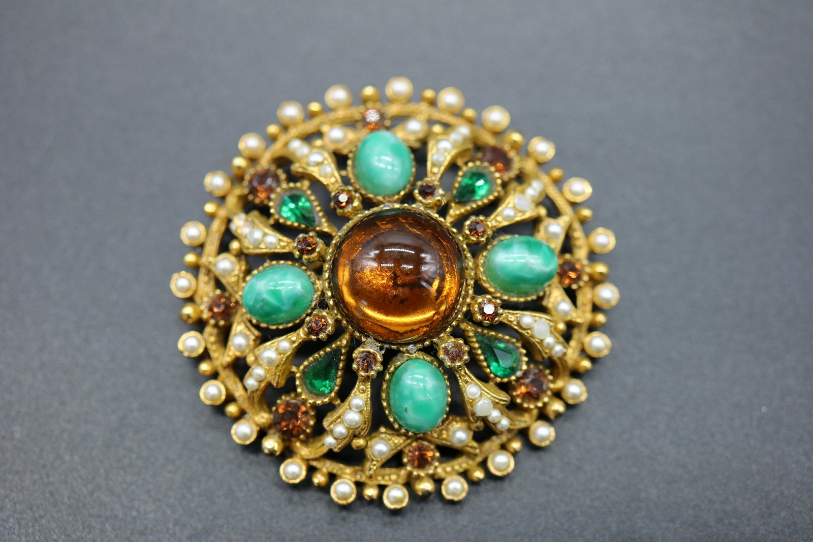 Vintage Capri Brooch, 1950-70's: round gold tone brooch with turquoise, amber and emerald green color stones with mini pearl beads, approx. 2 inches across