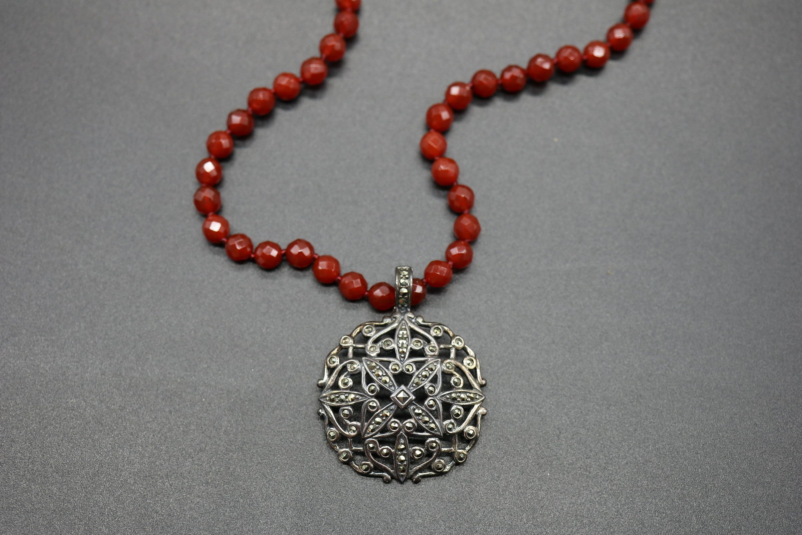 Vintage Hand Knotted Garnet & Sterling Necklace: 925A China marked on hand knotted necklace, beads appear to be garnet, marcasite pendant marked A925, Thailand, approx. 18 inch necklace and 1 3/4 inch pendant