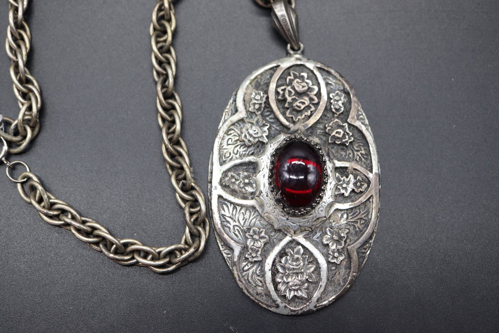 Large Vintage Pendant with Red Stone & Silver Tone: large carved floral silver tone pendant with large oval red stone in center, linked silver tone chain, no markings, approx. 3 1/2 x 2 1/4 inch pendant