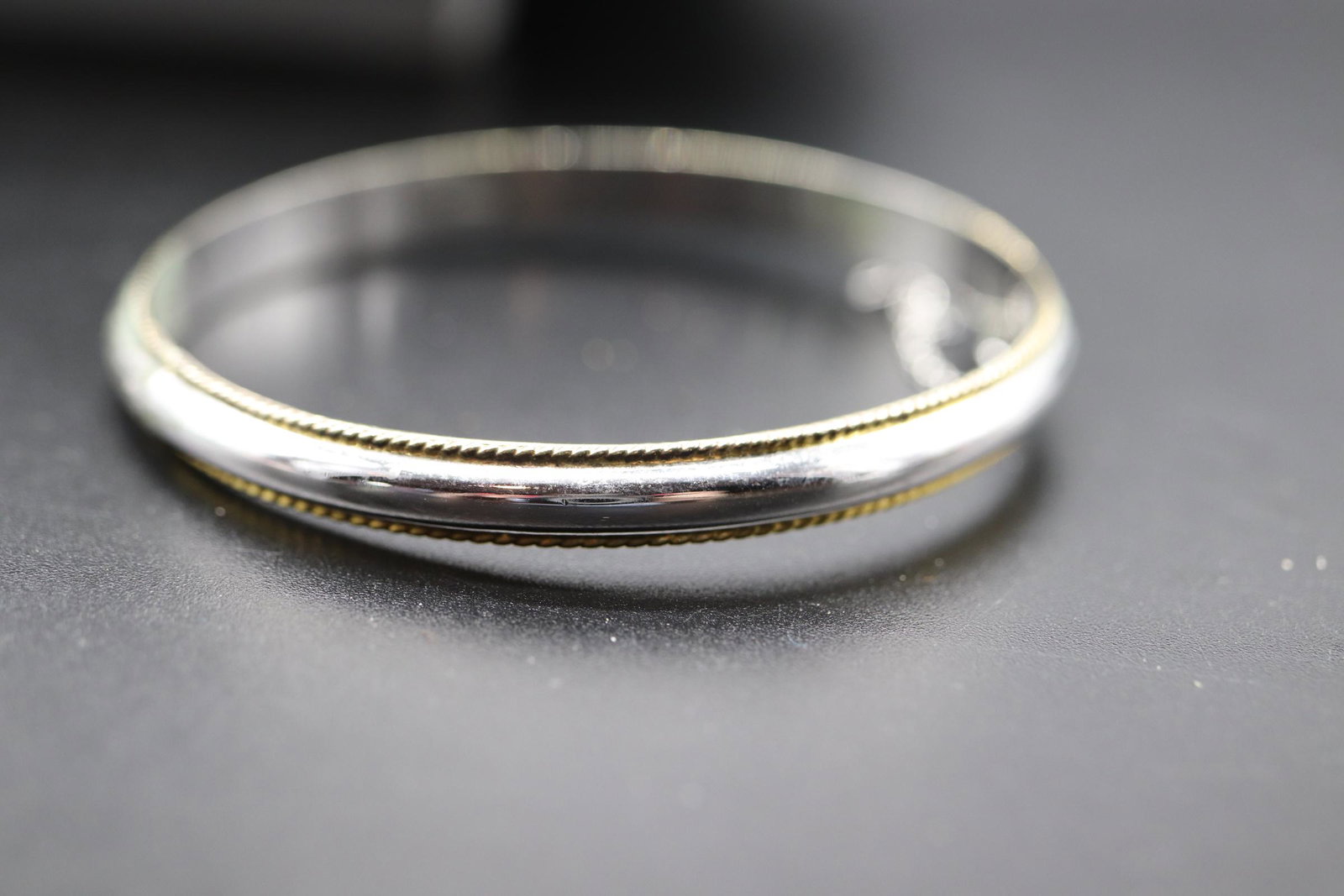 Artist Marked Sterling Bangle Bracelet: 925 sterling with artist mark, safety chain, approx. 2 1/2 inches across