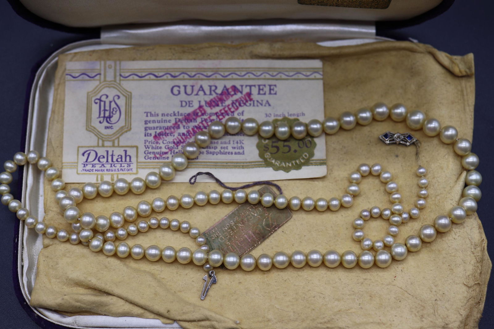 Vintage Deltah Pearl Necklace, 14K White Gold Clasp: in original velvet box, Gaurantee paper work, original cost $55. approx. 30 inch strand of pearls, 14k white gold clasp with saphires