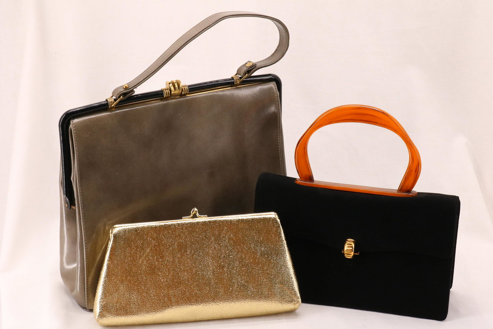 Lot of 3 Ladies Vintage Purses: gold clutch with chain by HL, green Italian leather by Lavalize, Black lucite and suede blend by Coblentz, all in nice condition or unused condition