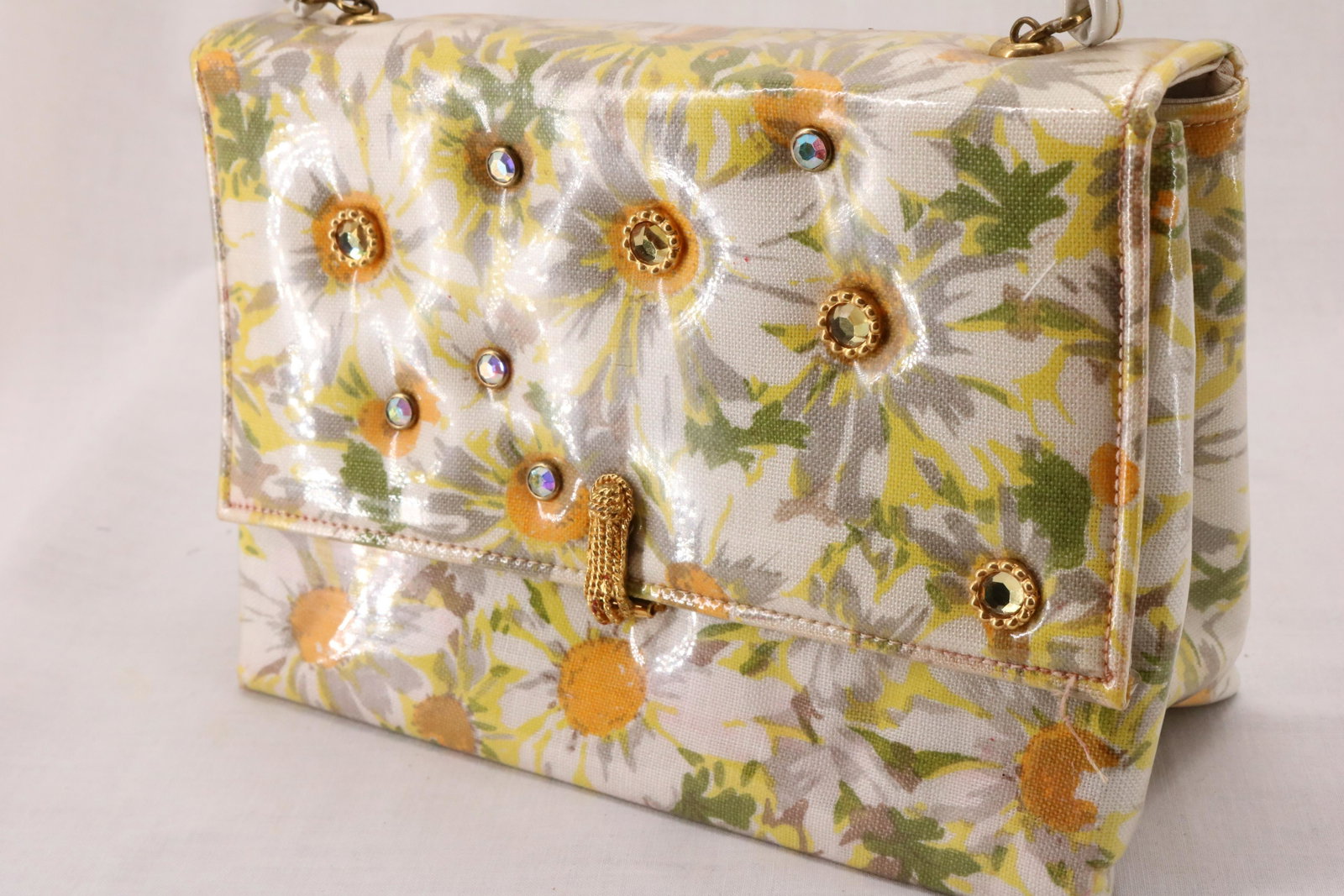 Vintage 1950's Daisy Print Hand Bag with Rhinestones: oringinal mirror in original paper bag, slight pink color spot on inside upper, otherwise great condition, approx. 8 1/4 wide, 6 inches tall not including handles