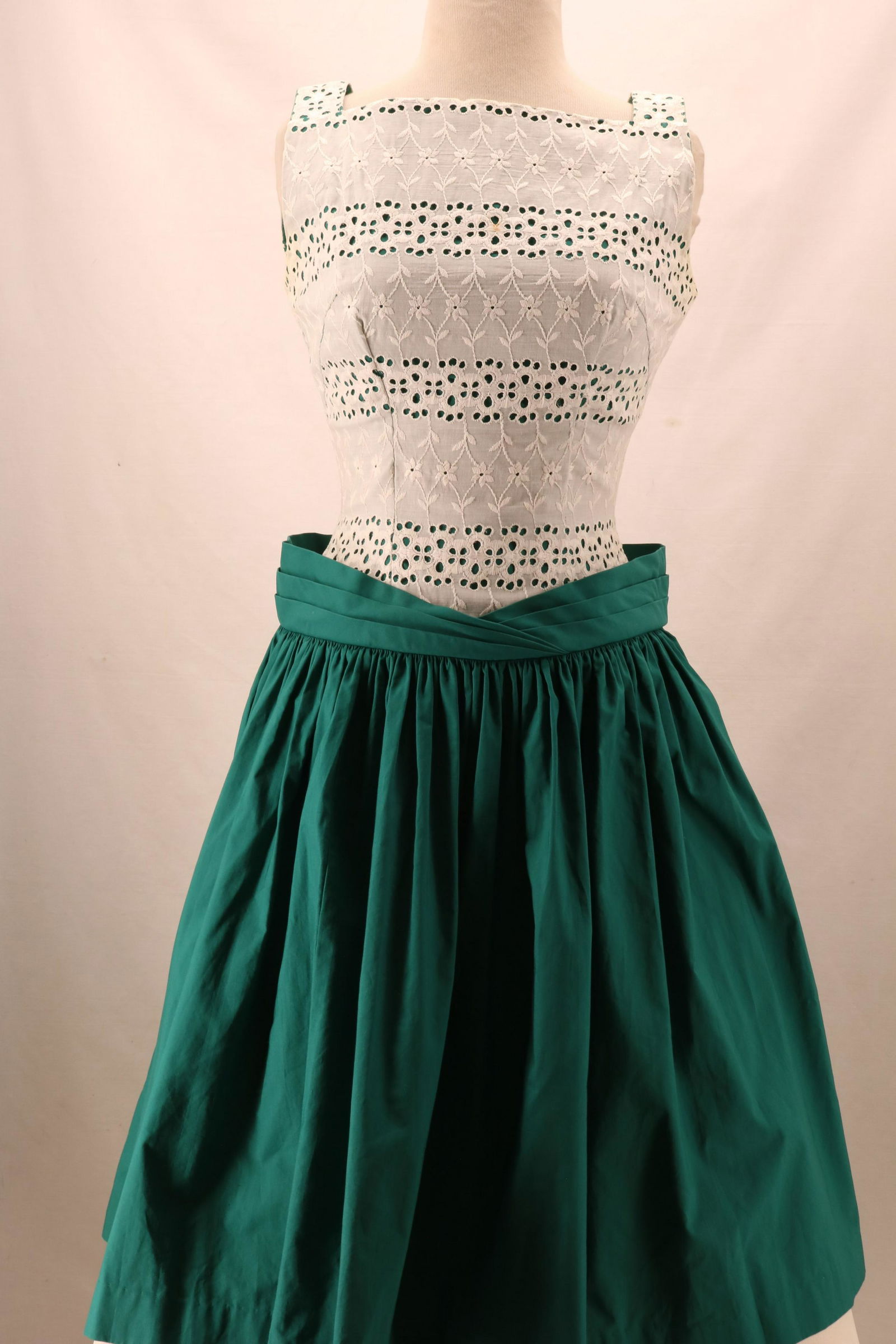 Vintage 1950's Eyelet Bodice Drop Waist Cotton Dress: Vintage 1950's Eyelet Bodice Drop Waist Green Cotton Dress with square neckline at the front and deep "V" at the back. Pleated waist band and full, gathered skirt. There is a mark at the front center