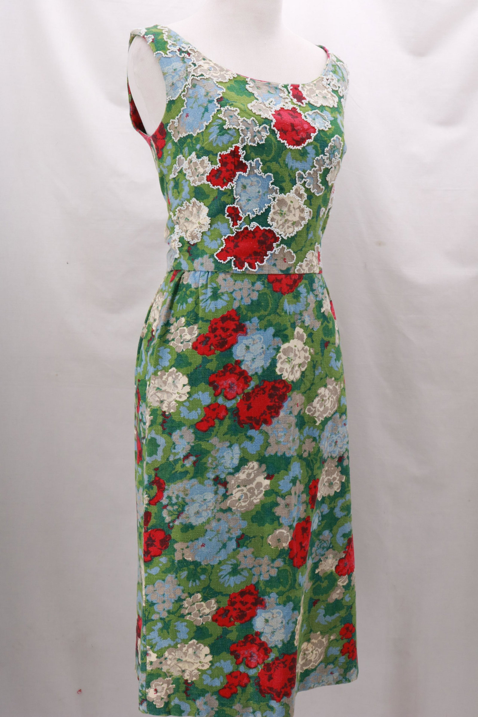 Vintage 1960's Bark Cloth Dress with Beaded Bodice: Vintage 1960's Bark Cloth Dress with Beaded Bodice Detail in a gorgeous floral design. Fully lined. Sexy 8" right side seam hem opening. 14" side zip opening. Approximate measurements: Bust 34", Waist