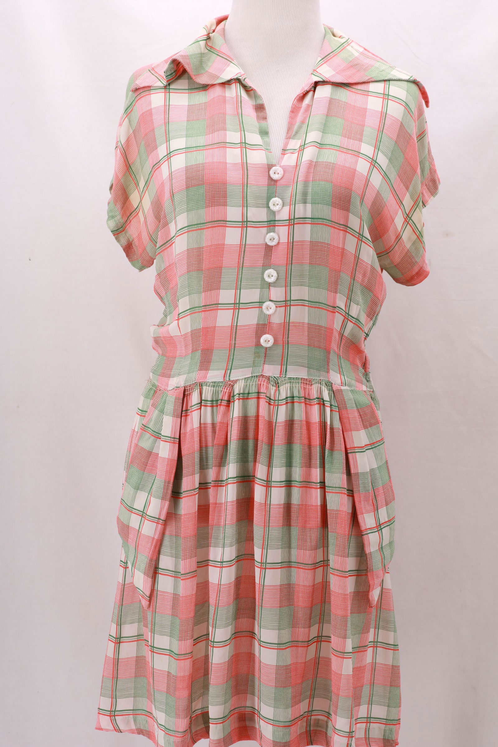 Vintage 1950's Orange & Green Plaid Dress: Vintage 1950's Orange & Green Plaid Dress with interesting faux pocket front design at the hips. Side seam metal zipper and six button detail at the front bodice. Tiny hole on back left shoulder- plea