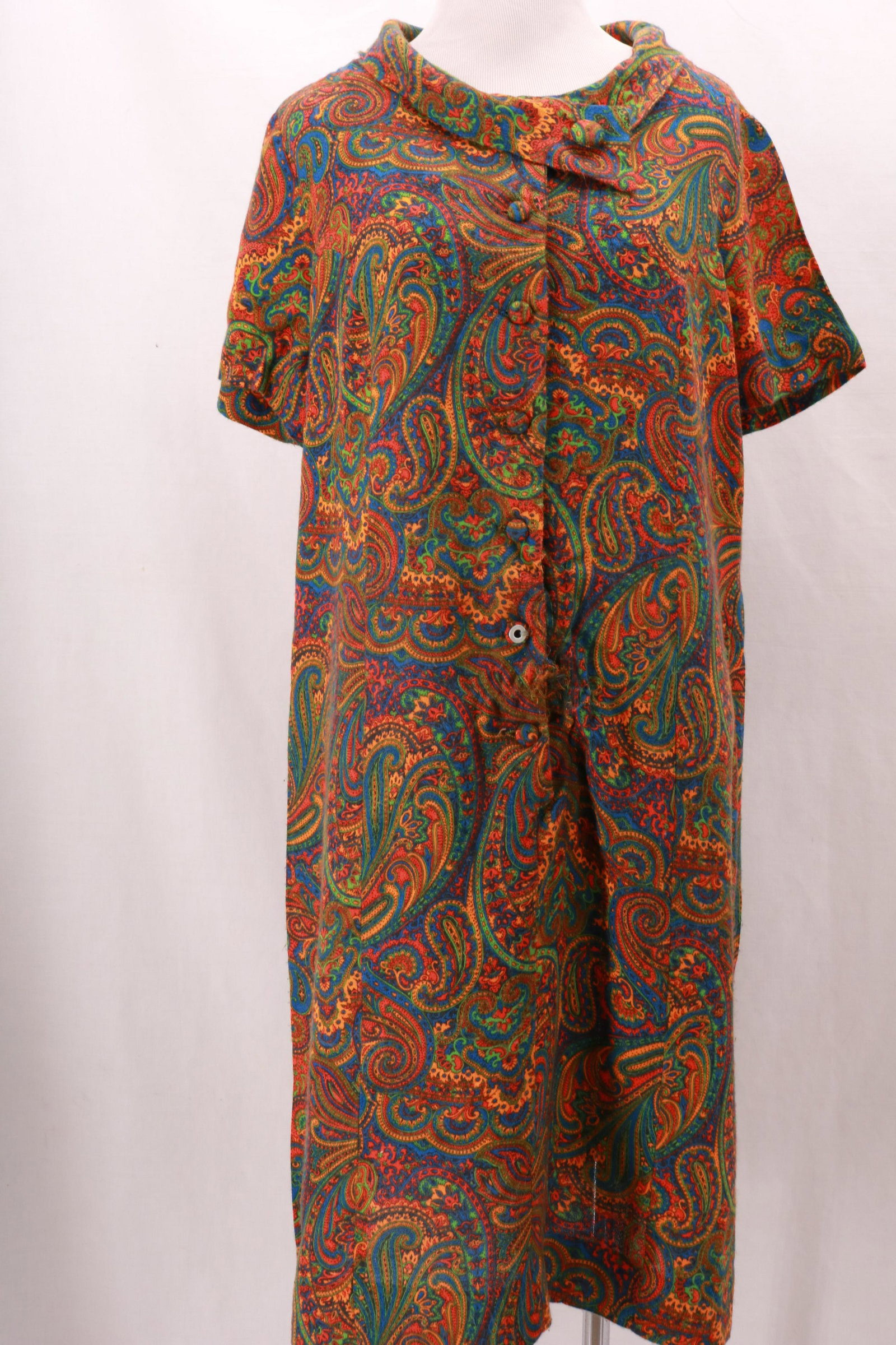 Vintage 1970's SIR ROB Paisley Dress: Vintage 1970's SIR ROB Paisley Dress with 7 button front opening. Asymmetric collar with button detail at the front and notch at the back. There are some pulls at the center front along the button pla
